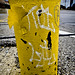Yellow ginkgo leaf on side of parking lot pole