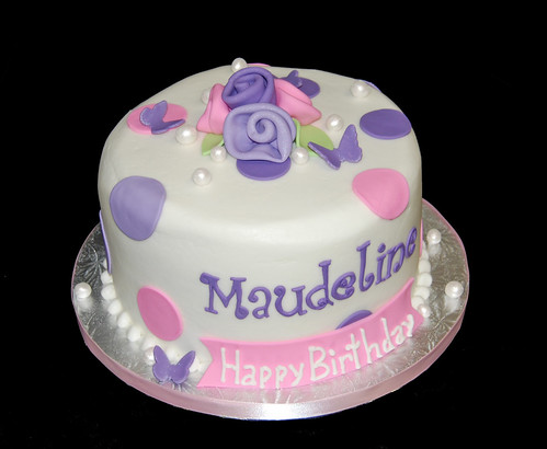 pink and purple polka dots woman's birthday cake with roses and pearls