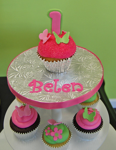 pink and green 1st birthday cupcake tower with butterflies and flowers