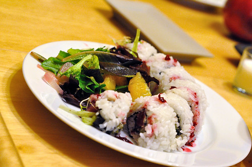 Pomegranate dressing salad, and sushi roll