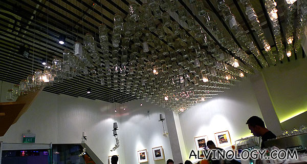 Rows of inverted wine glasses on the ceiling for decor