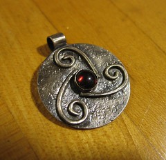 Triskelion pendant with garnet