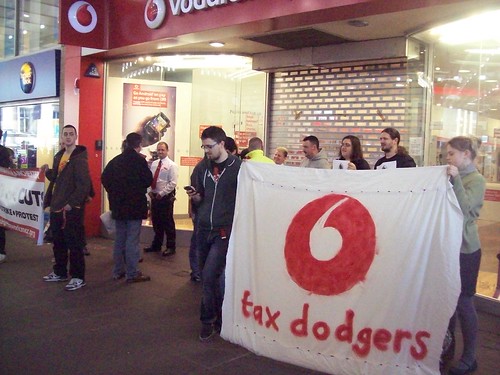 With a Vodafone tax dodger banner.