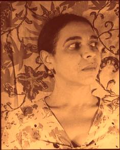 a sepia photo of Larsen. She is facing the camera but looking away apprehensively.