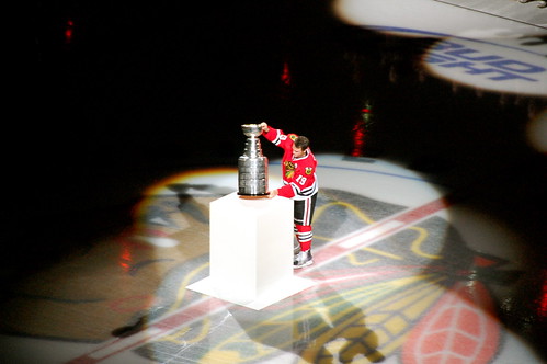 Toews placing the Stanley Cup down