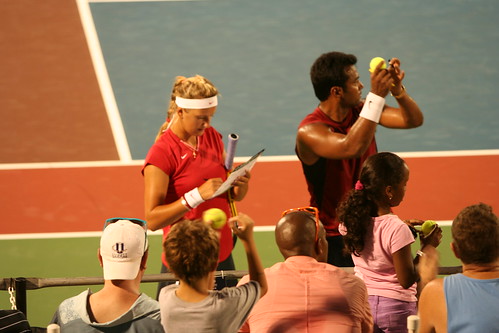 Signing balls after mixed doubles with Victoria Azarenka