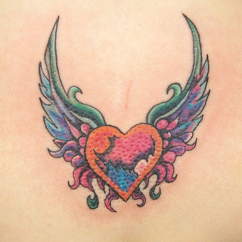 tribal wings back tattoo. Heart with wings on ack.