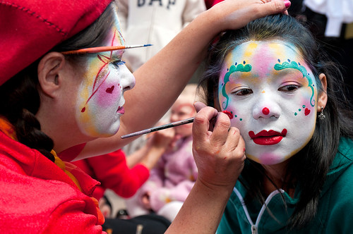 clown faces makeup. A make-up artist uses a girl#39;s