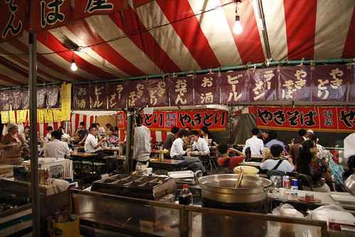 People eating at the food stalls during Mitama Matsuri