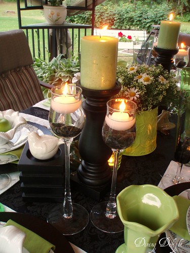 Pillar candles flank each side of the centerpiece Two glass stemmed pieces