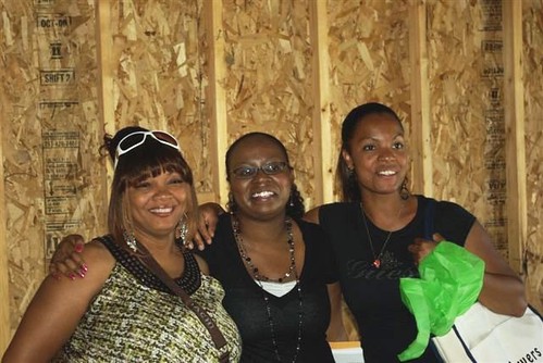 (From left) Carol Daniel, Jessica Jackson, housing counselor for YouthBuild McLean County and Natalie Powers are all smiles as Daniel and Powers begin moving into their new “green” homes in Carlock, Ill.