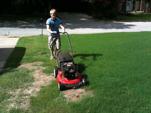 Alexander mowing the yard for the first time