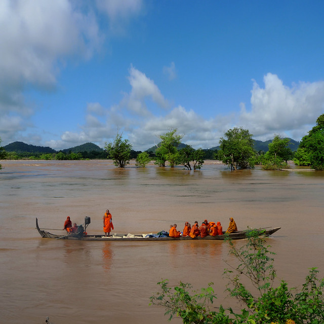 Monks on a slow boat at the Mekong River by B?n