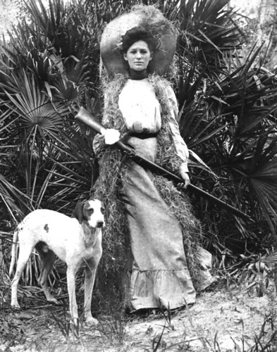 Woman with rifle and dog by State Library and Archives of Florida