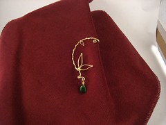 Ear cuff with thinner wire wrapped around it, making a vining look.