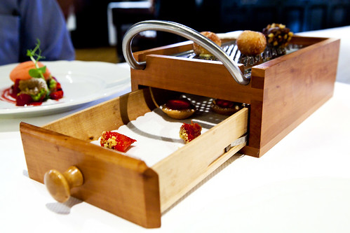A large grater box holding petit fours