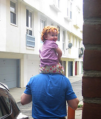 Speck on Daddy's shoulders, looking back over her shoulder at our doorway