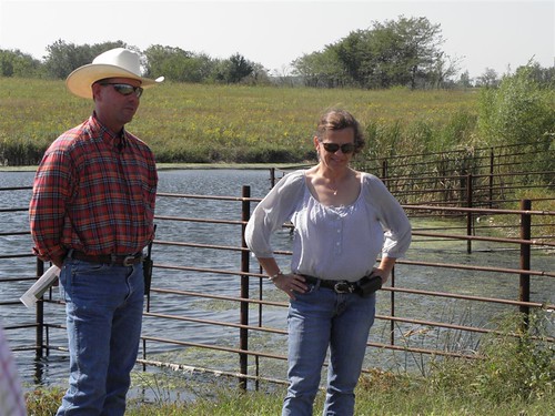 Joe Carpenter and Barbara Downey stand in front of their pond, which limits cattle access, prolonging the life of the pond and ensuring better water quality. The pride Joe and Barbara take in the care they provide both their animals and the resource base was evident, and they are communicating their love for the land to their two daughters as well.