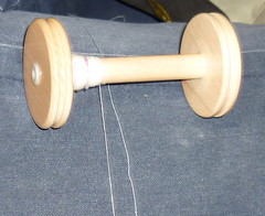 Merino singles on the bobbin next to the commercial sewing thread