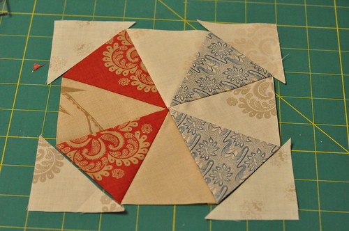 Sew triangles to the corners to complete the 12-piece kaleidoscope block