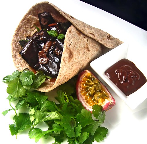 Chapatti wrap of pickled eggplant Sicilian style with fresh mint and coriander leaves served with a maracuja, chocolate, fried onions dip sauce