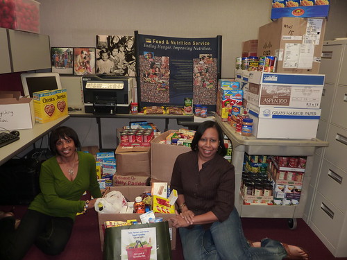 Angela Jones and Michelle Stewart with part of the donations collected by the Midwest Regional Office for the Feds, Farmers, and Friends Feed Families food drive.
