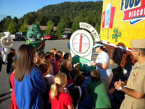 Eastern Kentucky school children react enthusiastically to the hero, Thermy™ and BAC!® the villain at the USDA Food Safety Discovery Zone.