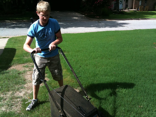 Alexander mowing the yard for the first time