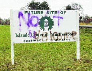 a roadsign that says Future site of Islamic Center of Murfresboro has been graffitted over to read Not Welcome