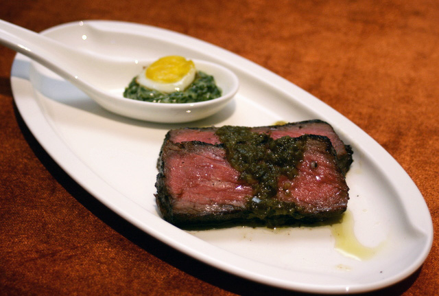 Wolfgang Puck's 300-day dry-aged Angus New York Strip with Chimichurri Sauce, plus Quail's Egg on Creamed Spinach