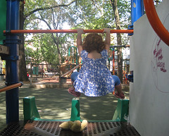 Speck performs the obligatory bar-hang before going down a slide; Tsah lies waiting her turn