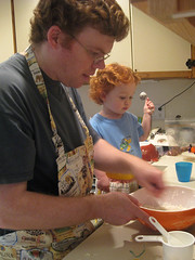 Speck helping Daddy do some baking, complete with aprons and measuring spoons