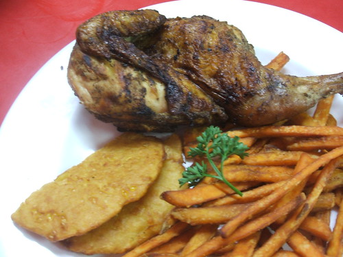 Half chicken with sweet potato fries and arepas