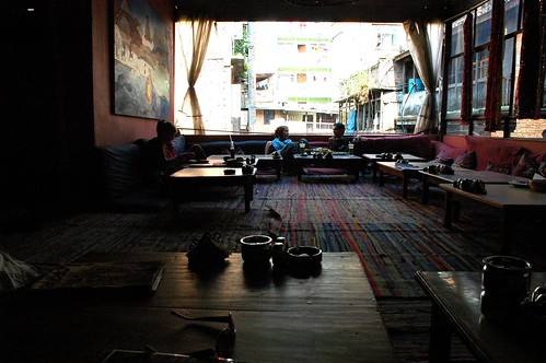 Friends chatting, Cool funky OR2K Restaurant, low tables, futons, wide open huge windows, Kathmandu, Nepal by Wonderlane