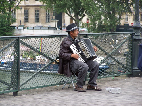 Accordion player on a bridge in Paris