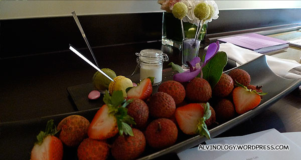 Complementary fruits, macarons and other dessert items from the hotel