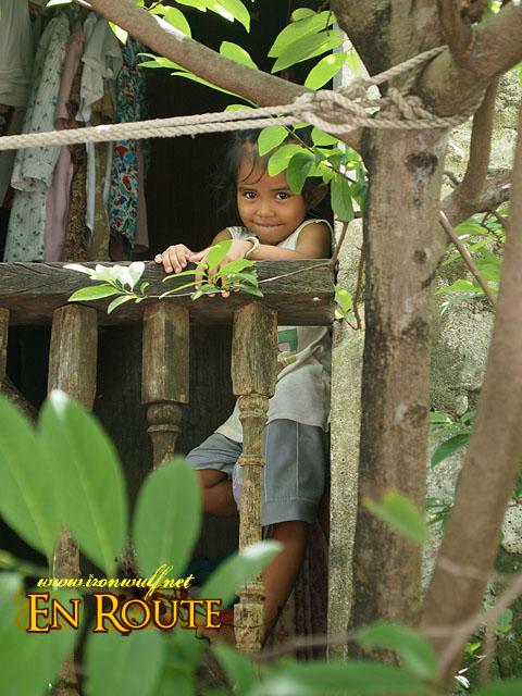 Kid at the Window behind the tree in Sabtang