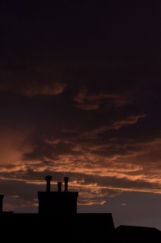orange and purple sunset over the silhouette of a chimney