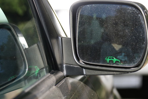 Image of side view mirror and car