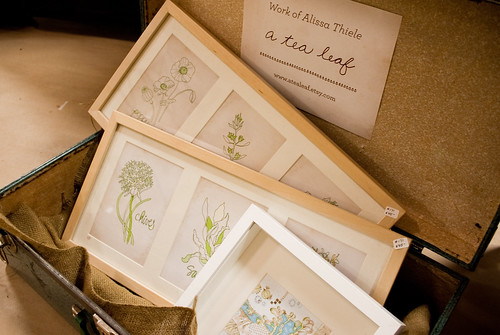 Herb art framings displayed in suitcase
