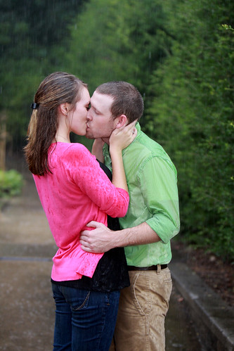 young couple kissing in the rain. young couple kissing in the
