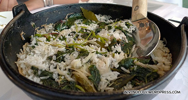 Rice served with organic greens in an earthen pot