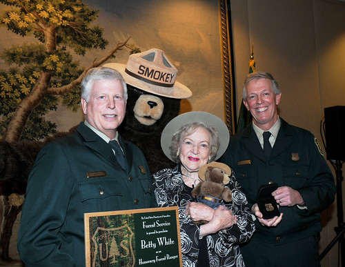 Actress Betty White holds the certificate and Forest Ranger badge presented to her by US Forest Service Chief Tom Tidwell (left) and Deputy Chief Hank Kashdan, as Smokey Bear looks on. White was named an Honorary Forest Ranger in a ceremony at the Kennedy Center for the performing Arts in Washington DC November 9. (US Forest Service photo by Karl Perry) 