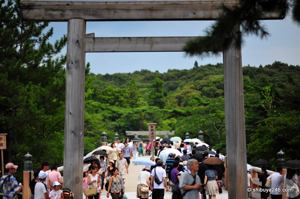 The entrance to Ise Jingu Naiku leads over a wooden bridge with beautiful mountain views