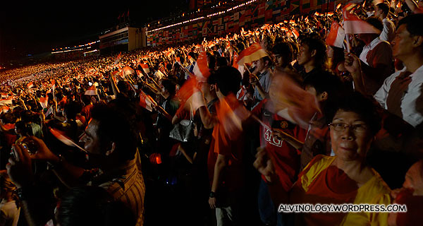 Audience proudly waving their Singapore flags