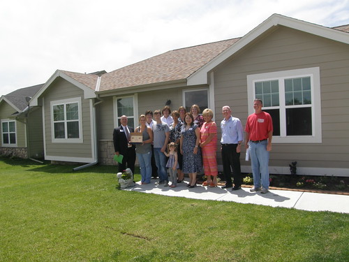 USDA Housing Administrator Tammye Trevino (fifth from right) Homeowners, builders and USDA officials stand in front of a home in Glenwood, Iowa financed with assistance from USDA Rural Development.  