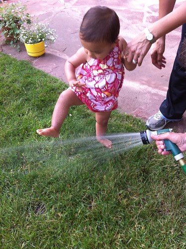 Laila playing in the water sprinkler