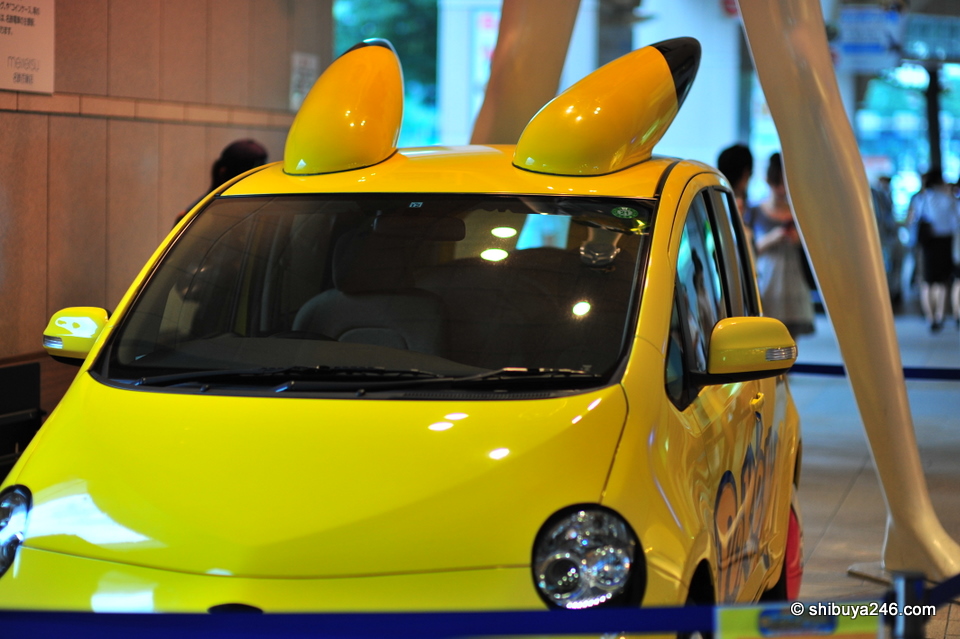 a pikachu car at the feet of Jane