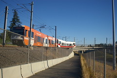 An airport bound train moves out onto the fishhook bridge at Gateway Transit Center