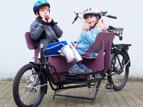 two kids in a long john bike